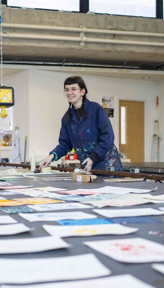 Textile designs students working with printing in studio