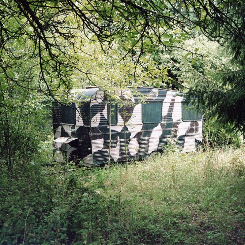 camouflage caravan within woodland