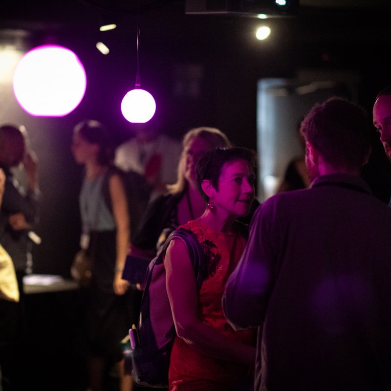 A group of people in purple light