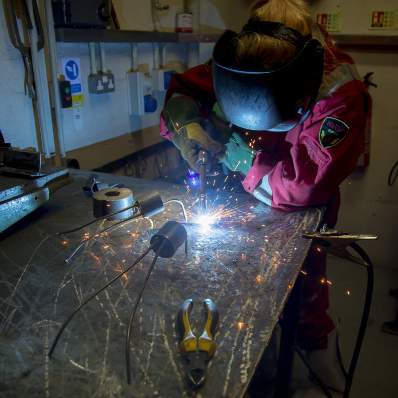 Student working in metal work studio