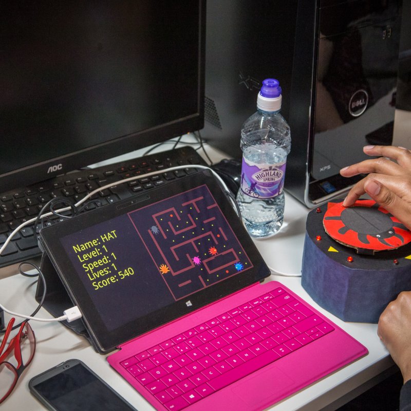 Student using a cylindrical touch controller.