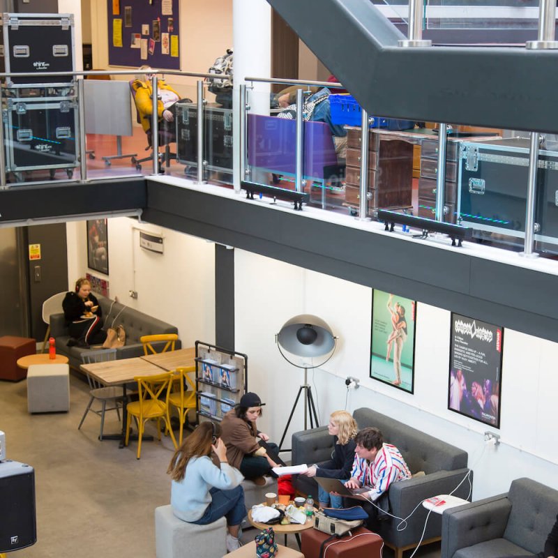 students sat in AMATA cafe with view of the staircase and seats