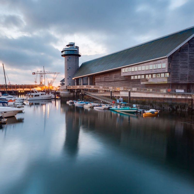View of the National Maritime Museum in Falmouth with boats and harbour in the foreground
