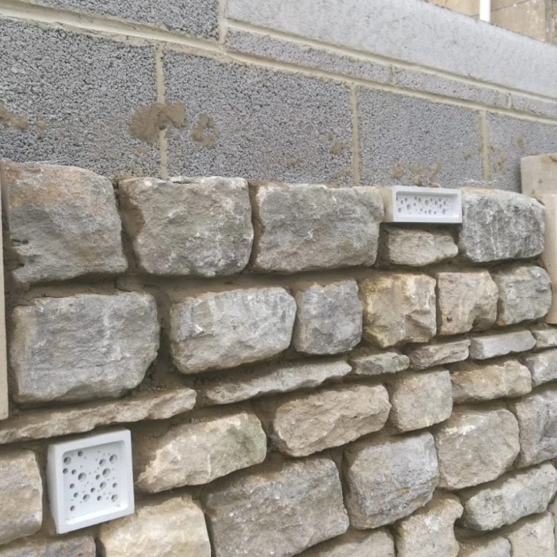 A stone wall being built with Bee Bricks
