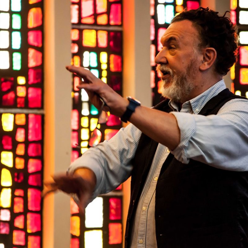 Portrait of Barry Purves in front of stained glass windows