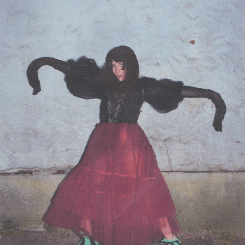 A girl in a black and red dress with blue and black heels