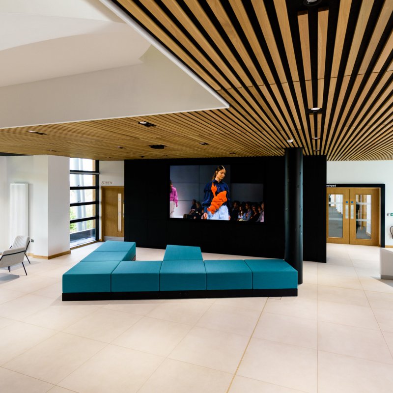 Open plan event space with large screen minimalist design and seating at the Creative Bridge