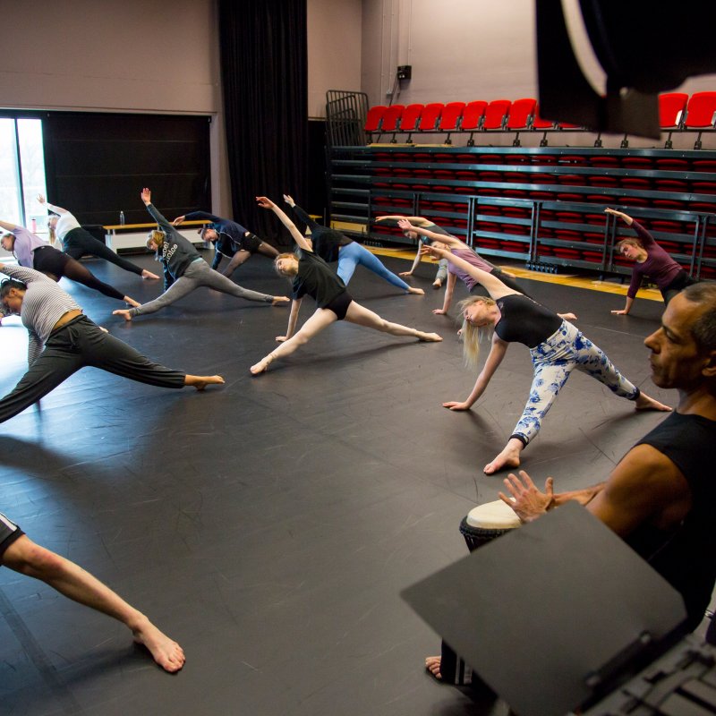 Dancers in studio stretching.