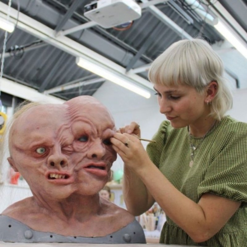 Prosthetic effects graduate Chase Hayden applies the finishing touches to one of her monsters