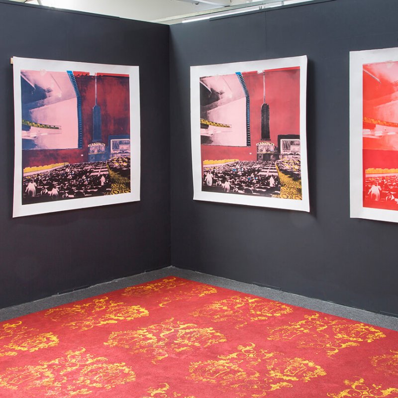 four prints displayed on a black wall