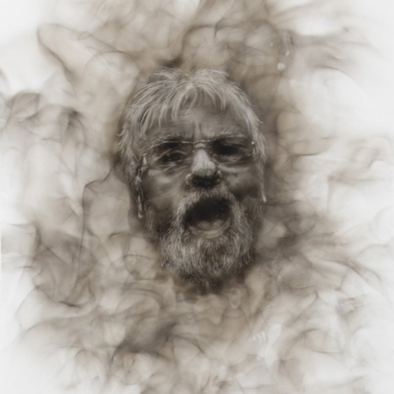 Detailed drawing of bearded man with mouth open and smokey effect framing his face