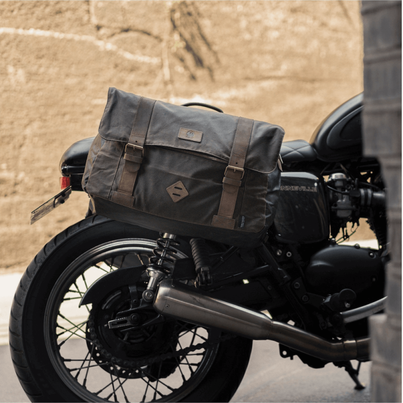 a leather bag strapped to the side of a motorbike