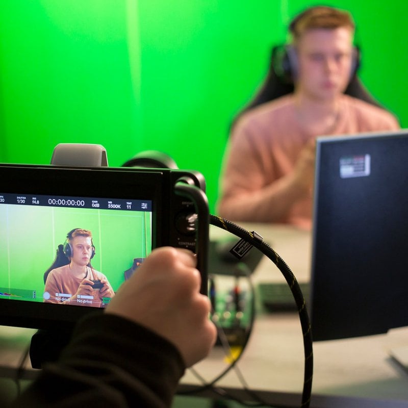 An Esports student being film with a green screen at Falmouth University