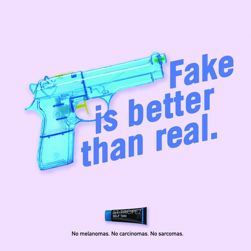 Blue toy gun with the text 'Fake is better than real'