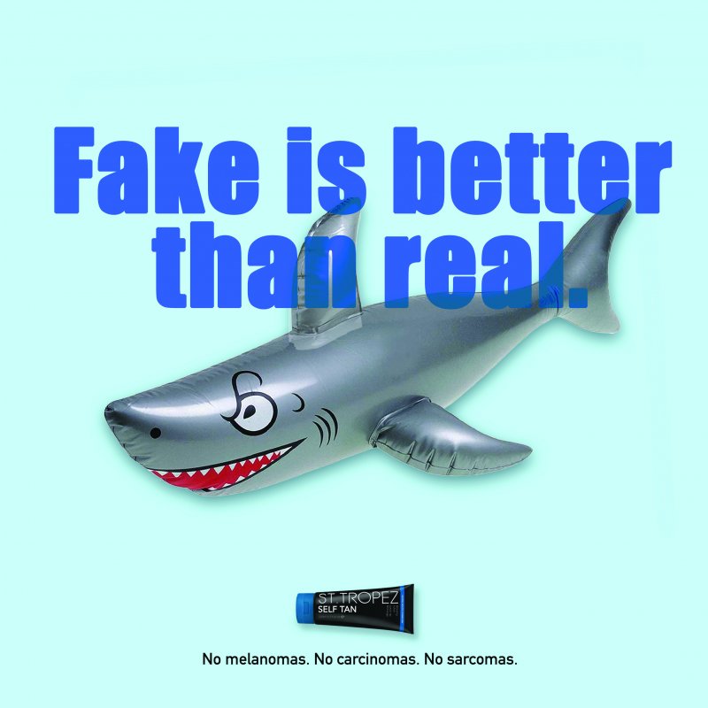 Blow up shark with the text 'Fake is better than real'
