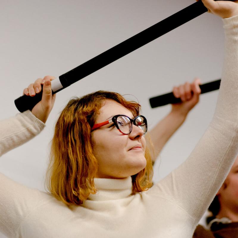 Film student holding a sound microphone above head