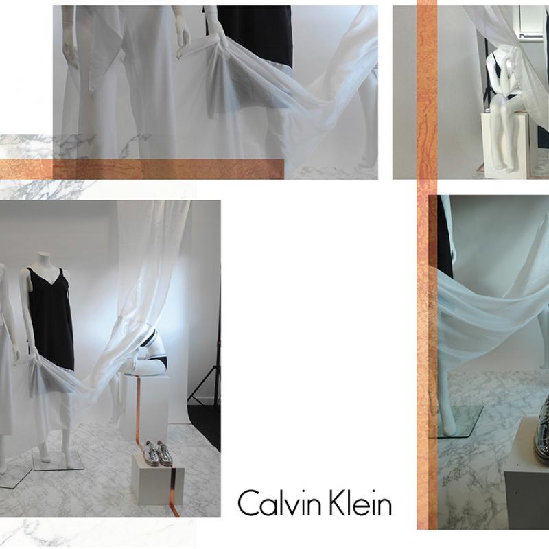 Mannequin display, white draping fabric and silver shoes.