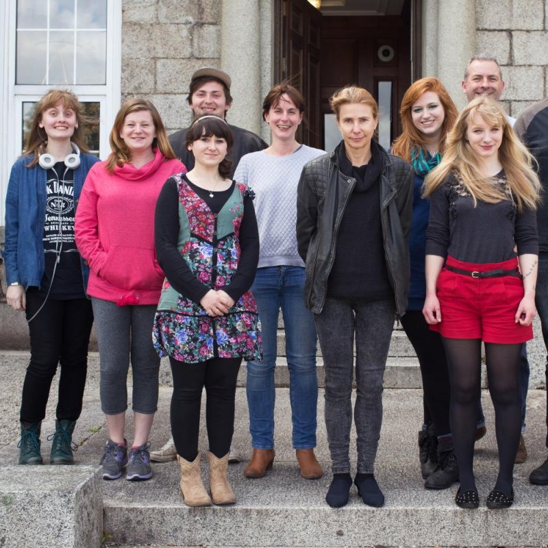 Group of Creative Writing students standing for portrait to welcome writer in residence, Lionel Shriver.