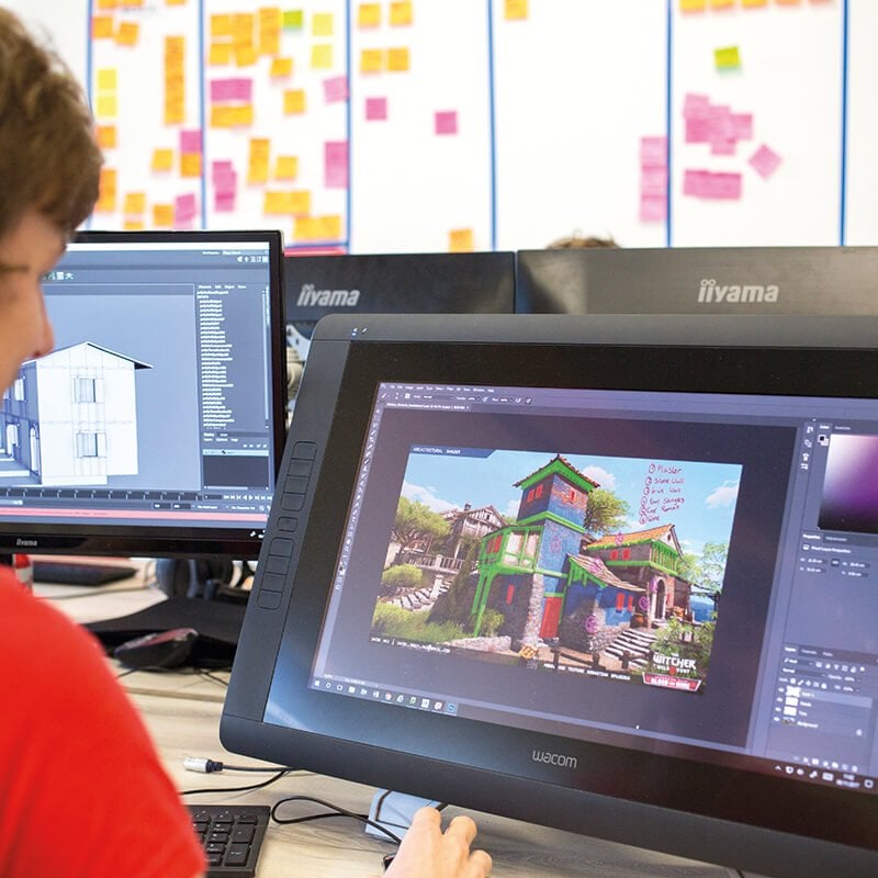 Games student working on digital game artwork on a screen.