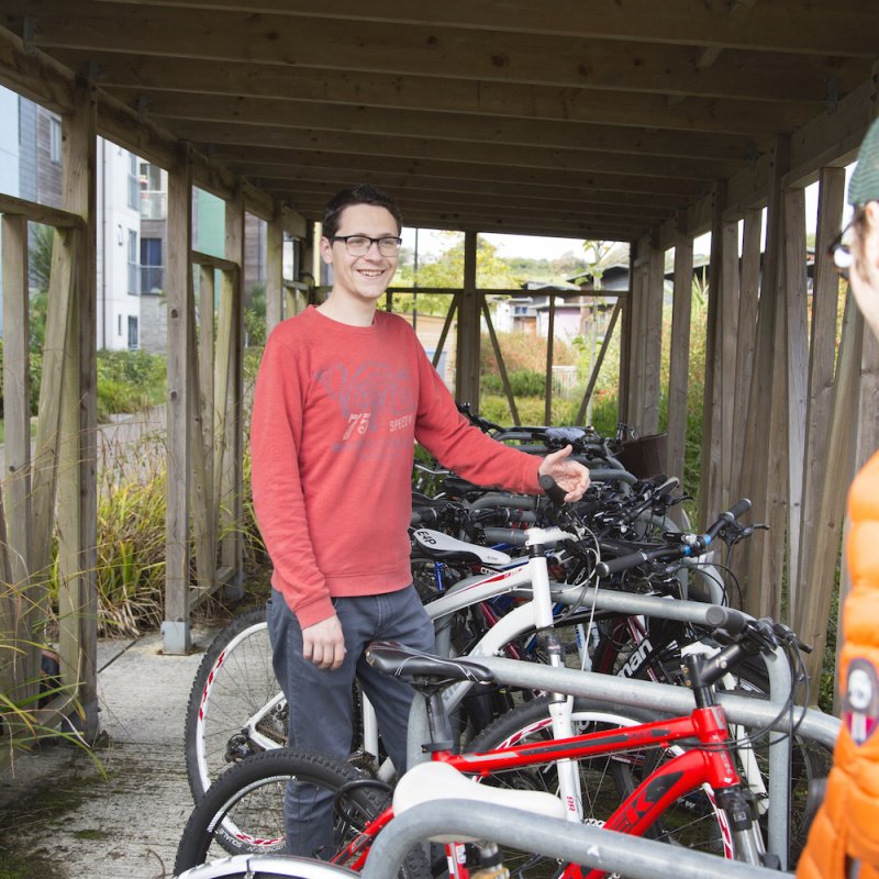 two students by a row of bikes