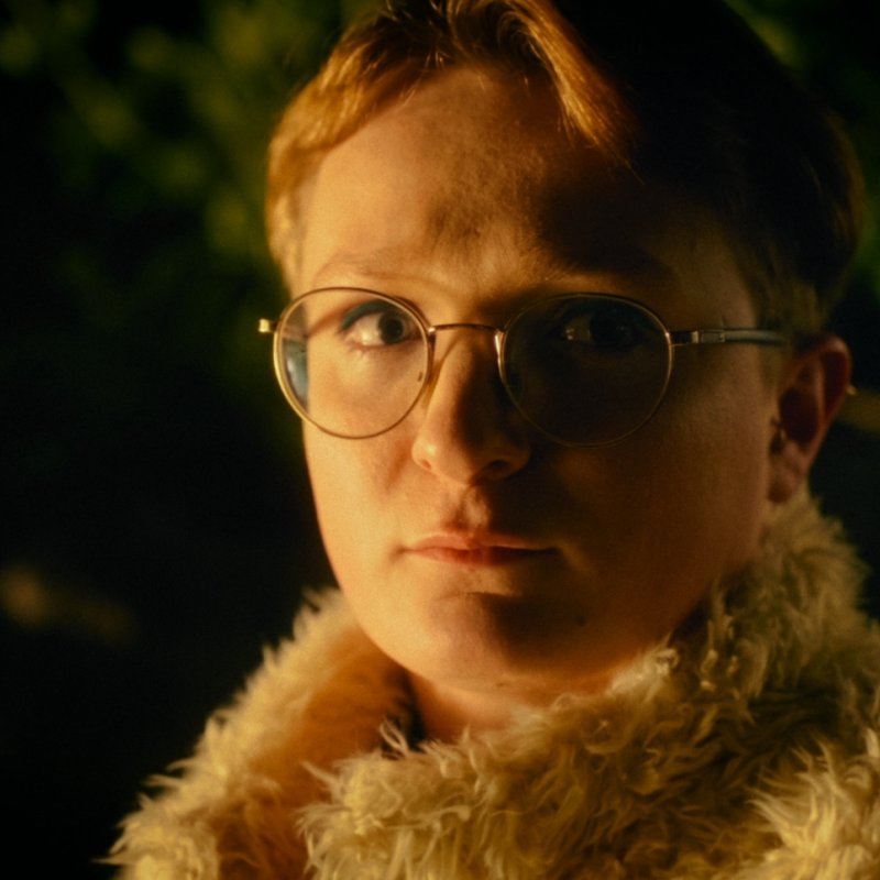 A character wears glasses and a fluffy coat in Heart Failure 