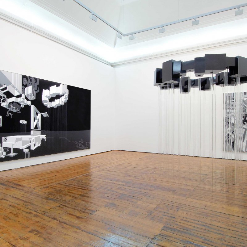 Gallery interior with large canvases on the wall and a metal installation