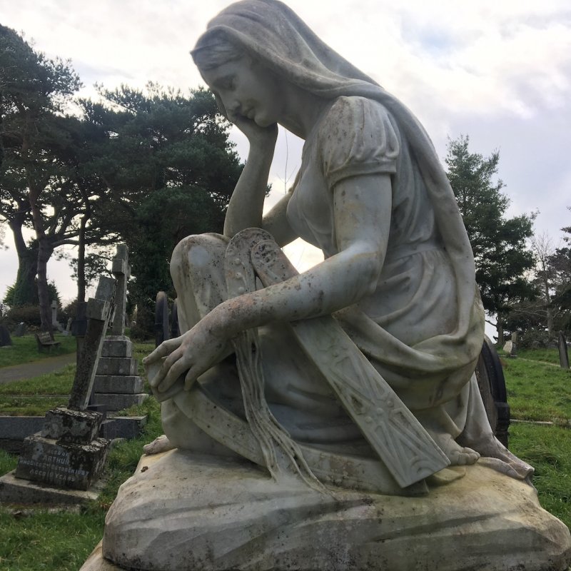 Headstone of a woman in a graveyard