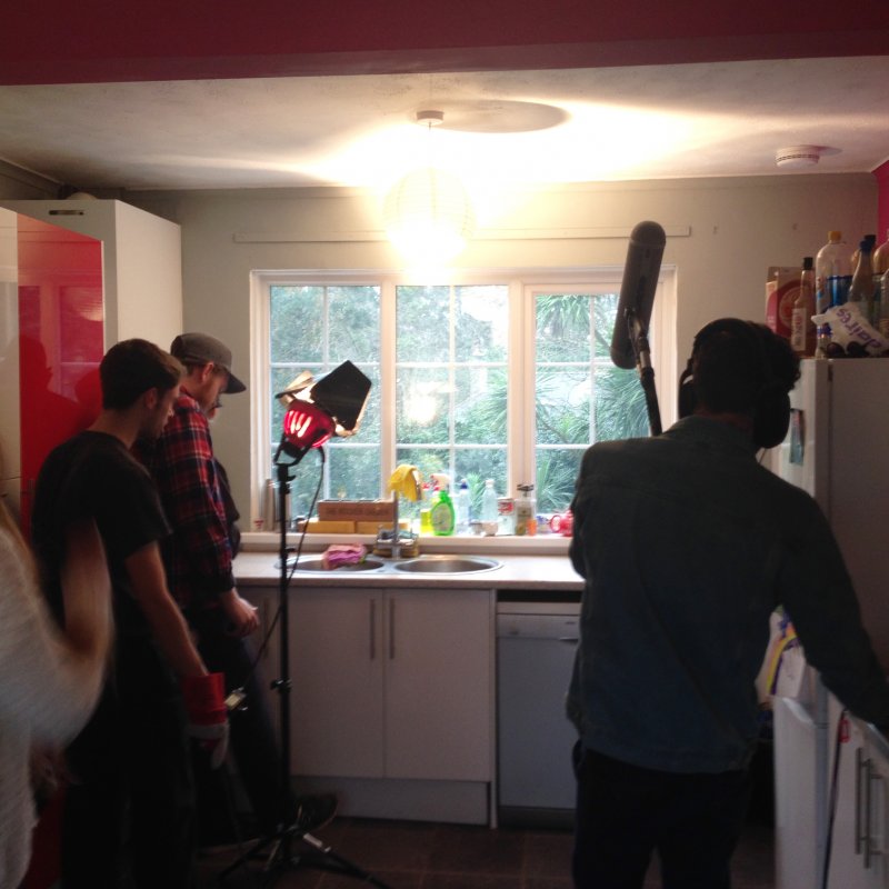 Students filming in kitchen.