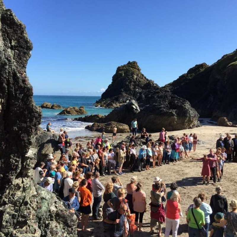 Audience on a beach watching dancers