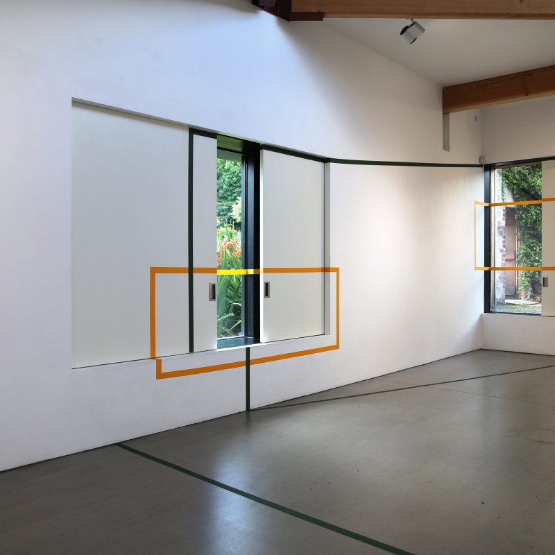 Gallery space with windows and an orange outline