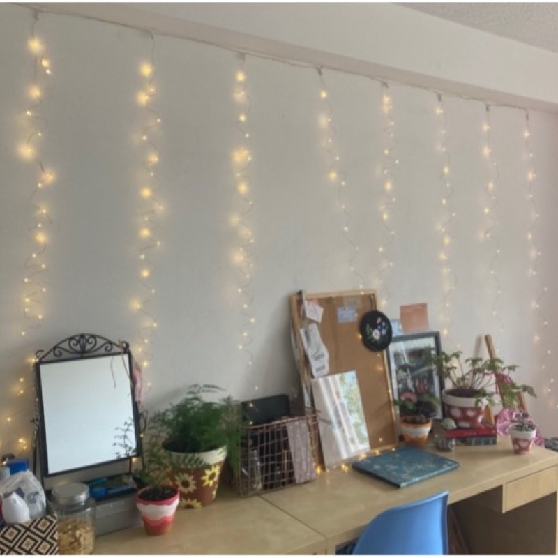 fair lights hanging above a desk in student bedroom