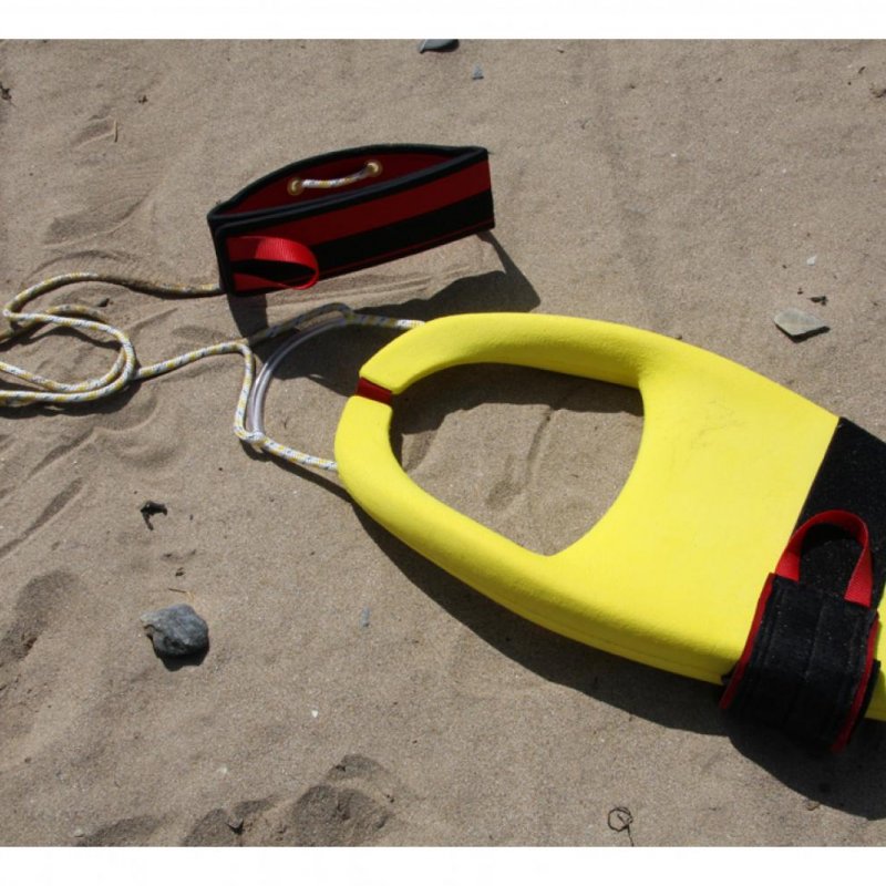Yellow life float design on sandy beach