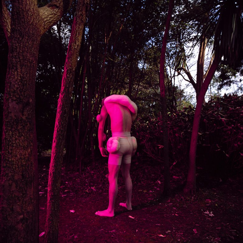 Male figure in the woods wearing white pants with padding on his body