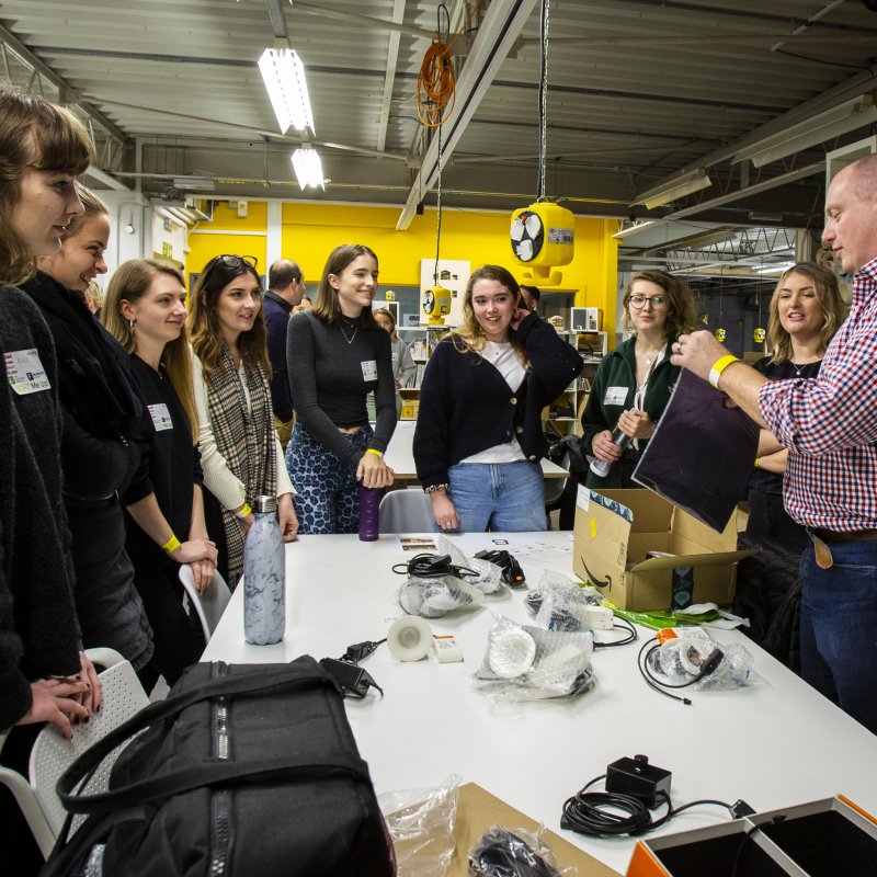 Interior Design BA(Hons) students standing around a table