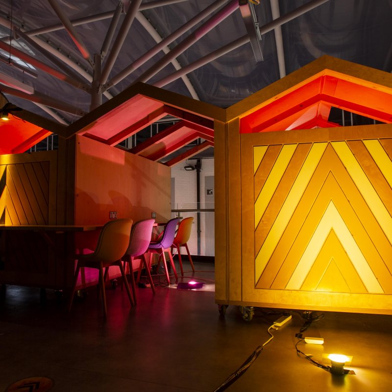 Wooden work spaces illuminated in yellow light