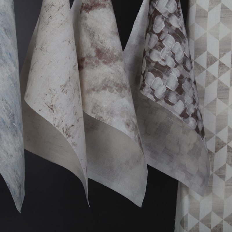 Samples of digitally printed fabric in whites and greys.