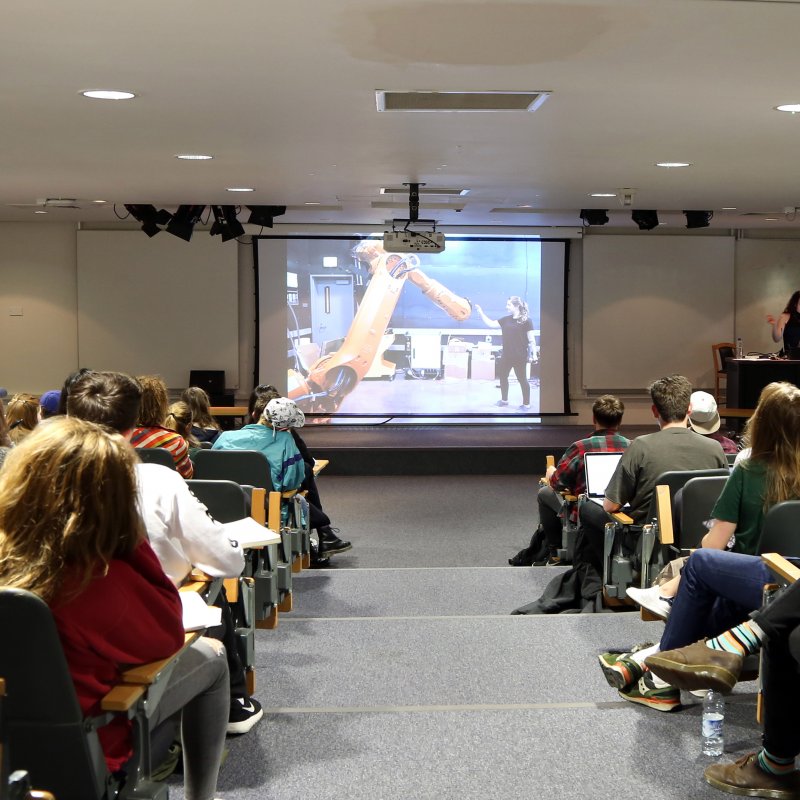 Students watching presentation in lecture theatre on Falmouth campus