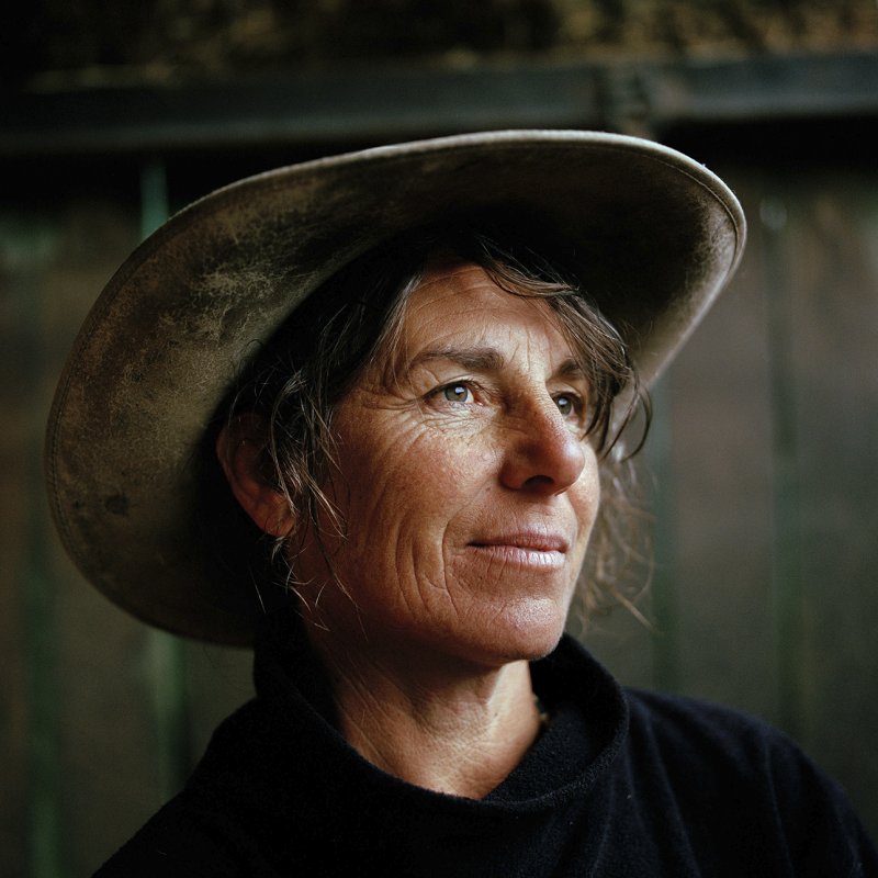 Head and shoulders portrait of woman in cowboy hat.