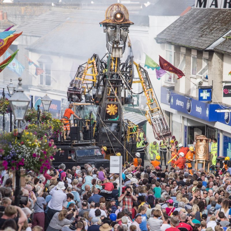 Crowd of people around the giant engine man scultpure