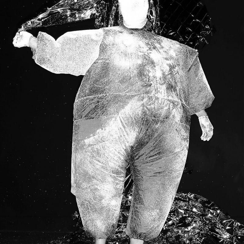 black and white image of a figure in a fat suit