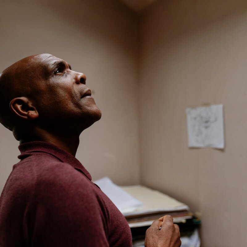 Denzil Forrester looking up at the ceiling in his studio