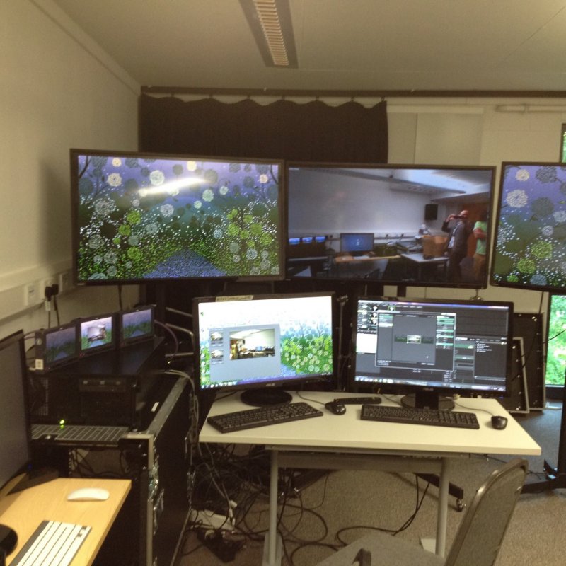 Five computer monitors in a room