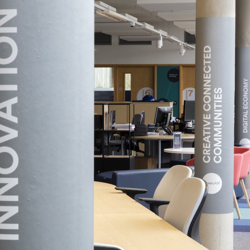 Building interior with innovation written on a grey pillar