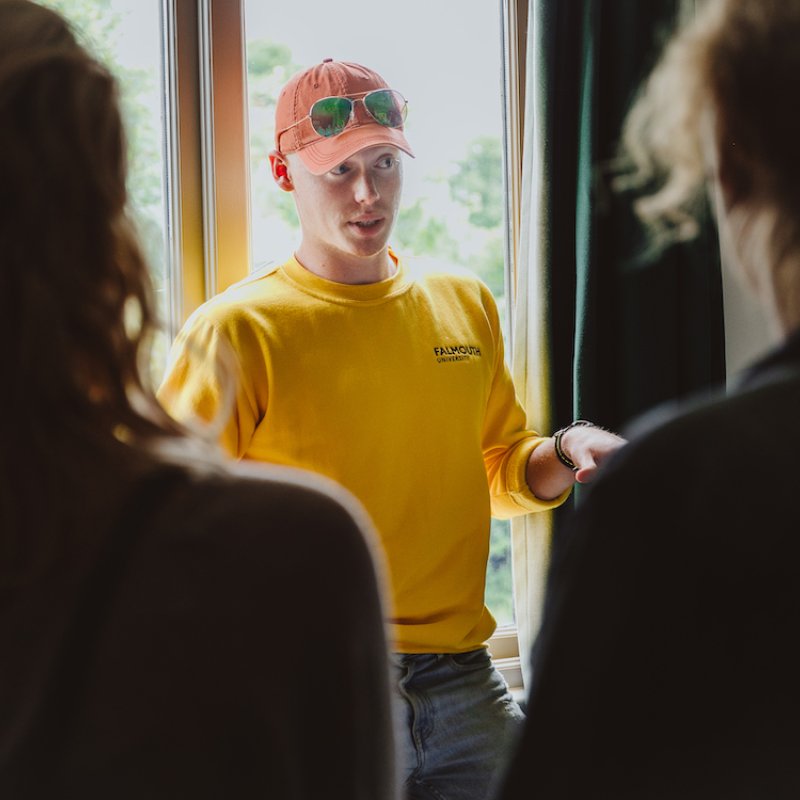 Student ambassador stood in front of window talking to group.
