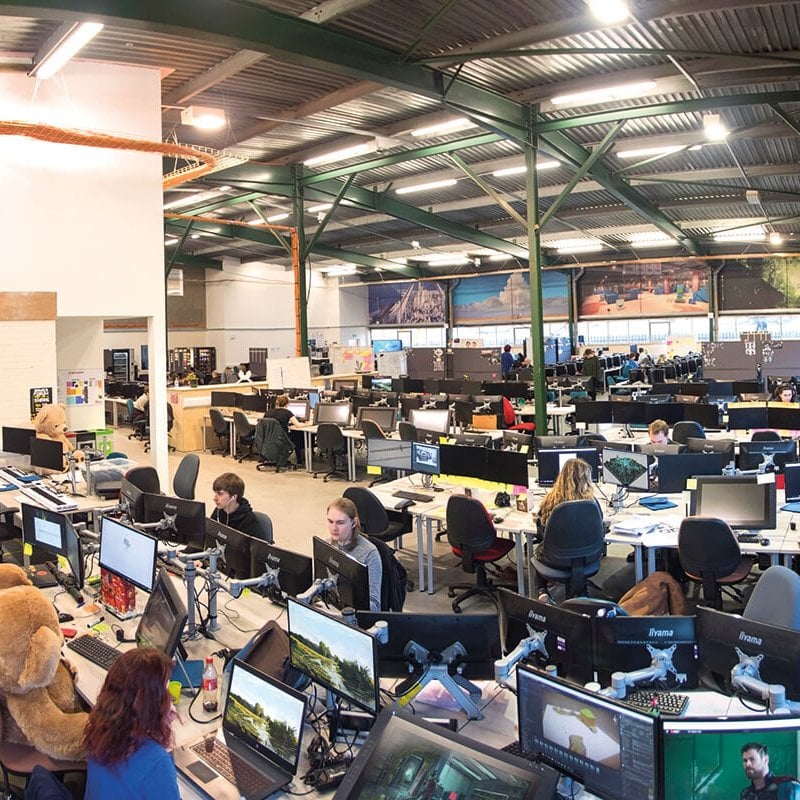 View of busy games academy, students working on computers