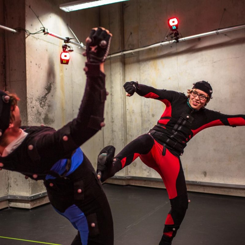 Two Falmouth University Game students in motion capture suits fighting