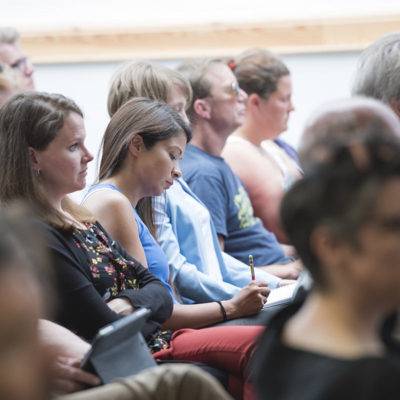 Men and women seated in a crowd