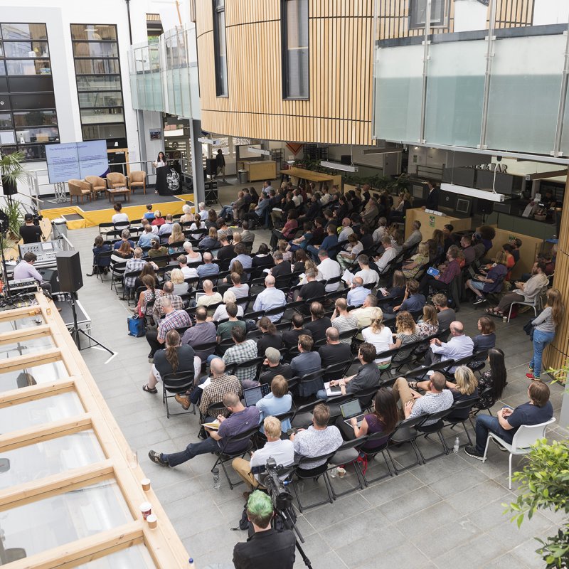 Delegates seated in front of a stage for an event in Fox Cafe 