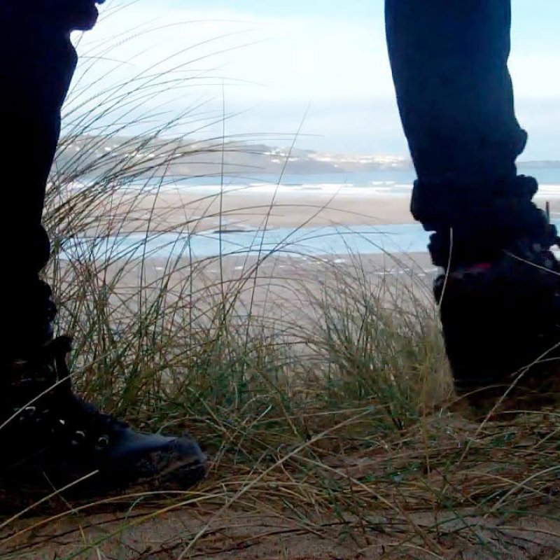 Photo of two feet on the sand