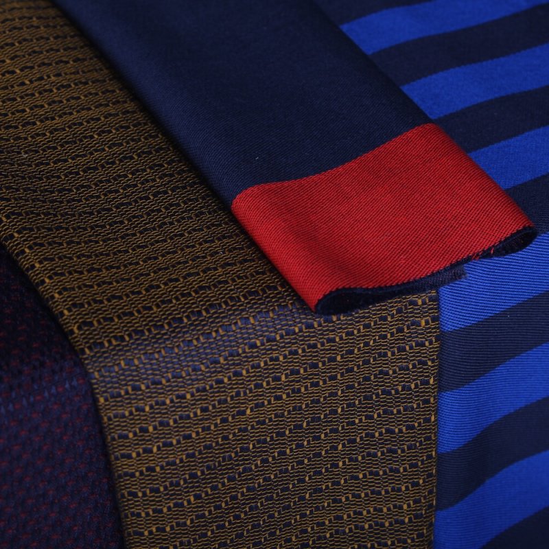 Hand woven fabric samples in dark blue and red colours.